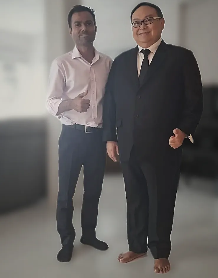 A finished black suit with the tailor, in the customer's apartment.