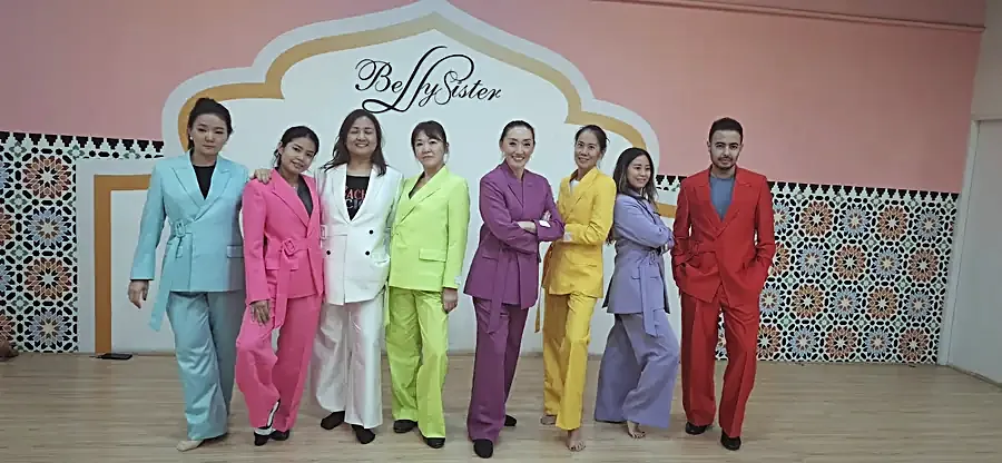 Eight belted trouser suits cut to one pattern in eight colours — mint, pink, white, lime, purple, yellow, lilac and red.