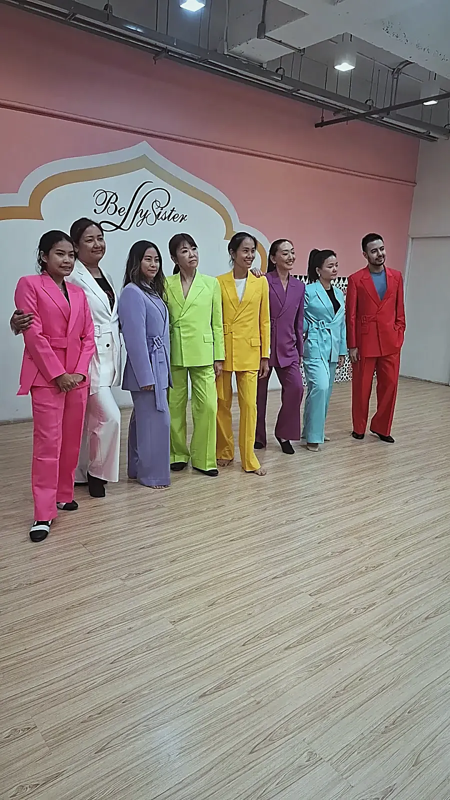 Eight trouser suits from one pattern, lined up in eight colours.