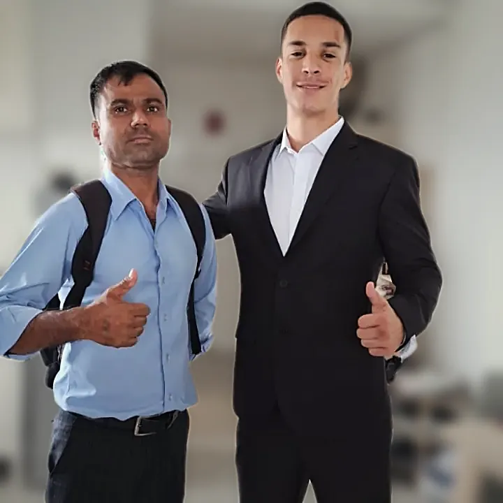 A finished dark suit with the tailor who made it, in the customer's apartment.