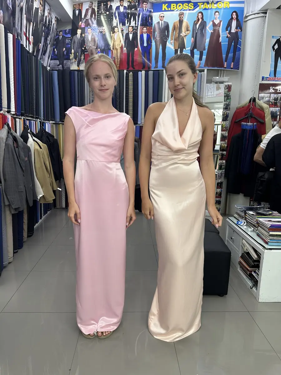 Two evening gowns cut to measure, in pink and blush silk.