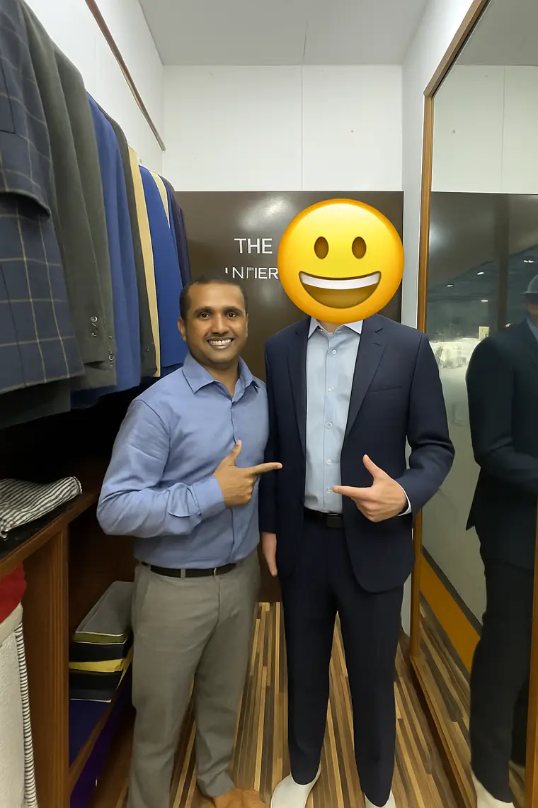 The navy suit the review says needed no alterations at the first fitting, with one of the tailors pointing it out. The reviewer covered their own face with a sticker.